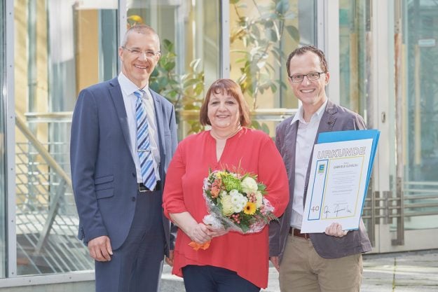 Klaus Müller (l.) und Harald Krieg (r.) gratulierten der Jubilarin und überreichten ihr eine Urkunde sowie einen Blumenstrauß als Dankeschön.